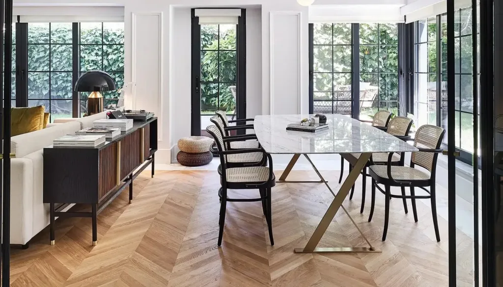 A cozy living room with a stylish dining table and chairs, creating a perfect space for meals and gatherings.