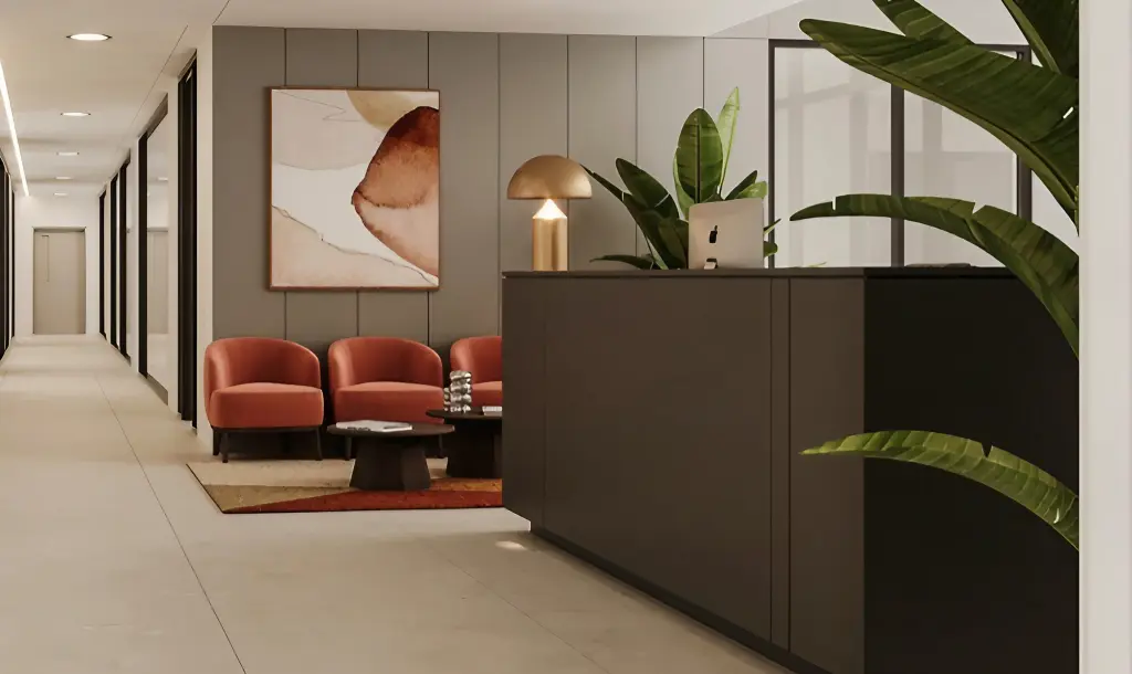 a modern office lobby with a reception desk red armchairs a coffee table a large abstract painting and several potted plants - interior design in ireland